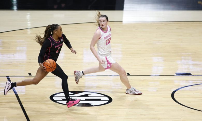 Vanderbilt guard Mikayla Blakes drives around Oklahoma guard Payton Verhulst during a 2025/26 NCAA basketball game.