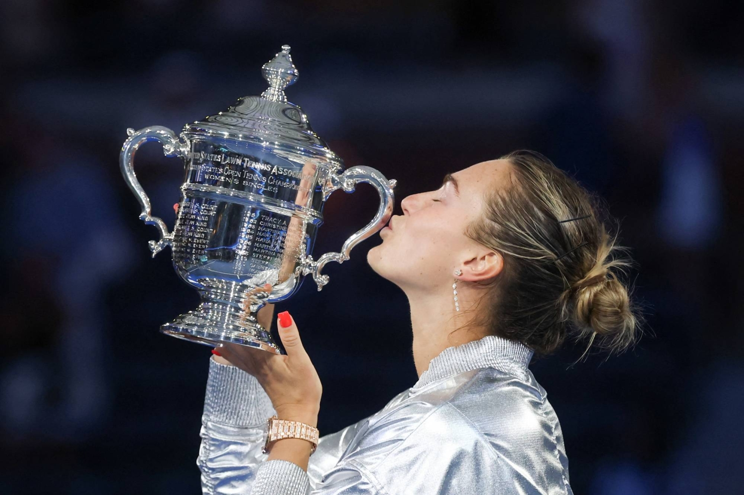Aryna Sabalenka celebrating with trophy after winning Grand Slam title