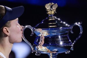 Kazakhstan's Elena Rybakina holds the Daphne Akhurst Memorial Cup after her victory against Belarus' Aryna Sabalenka during the women's singles final match on day fourteen of the Australian Open tennis tournament in Melbourne on January 31, 2026. (Photo by Izhar KHAN / AFP) / --