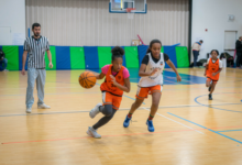 Girl basketball player training on court with ball-handling shooting and defensive drills